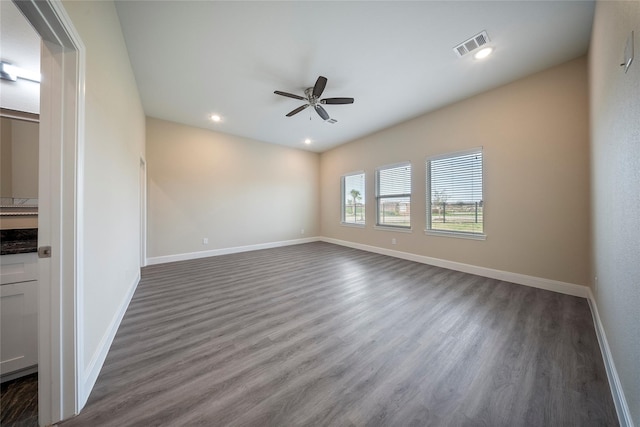 unfurnished room with dark wood-style flooring, a ceiling fan, baseboards, recessed lighting, and visible vents
