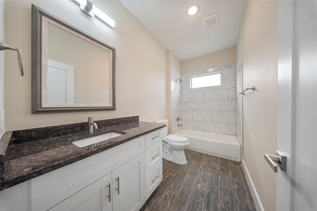 bathroom featuring vanity, toilet, shower / bath combination, wood finished floors, and visible vents
