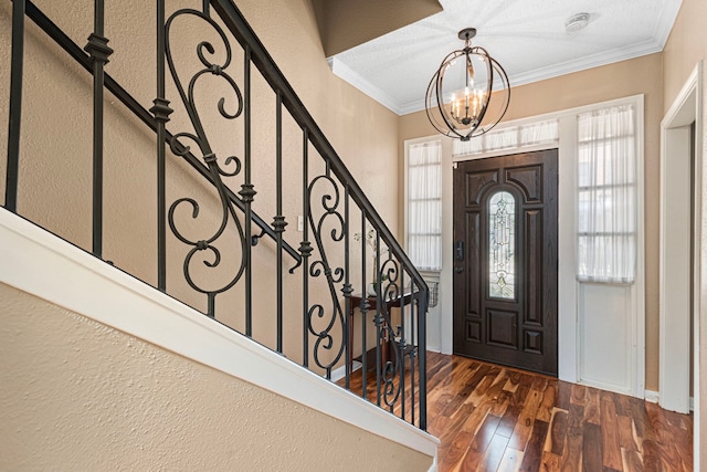 3749 Wakeforest St, Houston, TX 77098 - foyer entrance featuring dark wood finished floors, crown molding, stairs, and a chandelier