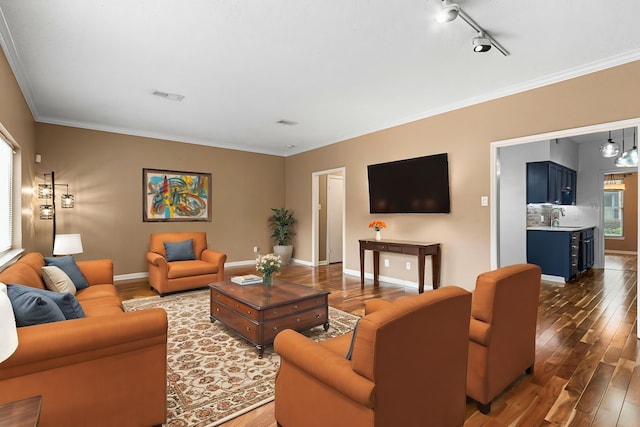 3749 Wakeforest St, Houston, TX 77098 - living area featuring wood finished floors, crown molding, baseboards, and track lighting
