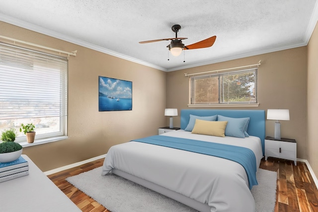 3749 Wakeforest St, Houston, TX 77098 - bedroom featuring baseboards, crown molding, wood finished floors, and ceiling fan