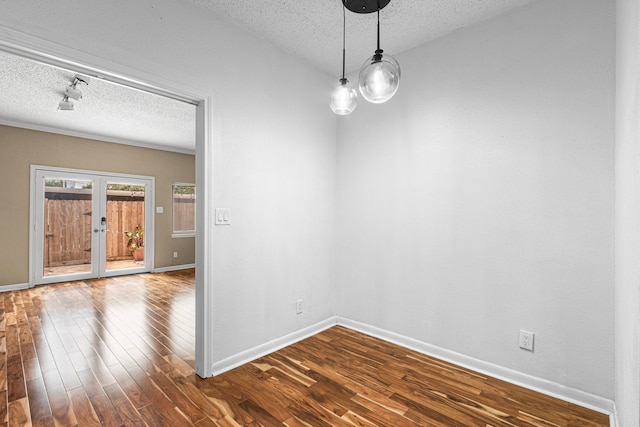 3749 Wakeforest St, Houston, TX 77098 - empty room with a textured ceiling, dark wood-type flooring, baseboards, and french doors
