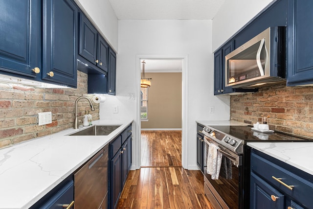3749 Wakeforest St, Houston, TX 77098 - kitchen with stainless steel appliances, a sink, blue cabinetry, and dark wood-style floors