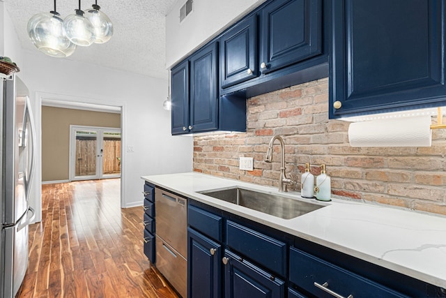 3749 Wakeforest St, Houston, TX 77098 - kitchen with blue cabinets, a sink, appliances with stainless steel finishes, a textured ceiling, and hardwood / wood-style floors