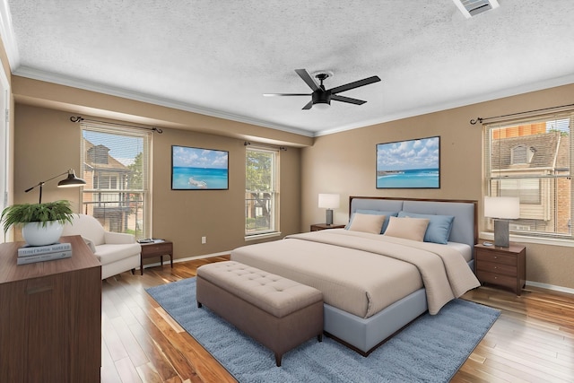 3749 Wakeforest St, Houston, TX 77098 - bedroom with a textured ceiling, ornamental molding, hardwood / wood-style flooring, baseboards, and a ceiling fan