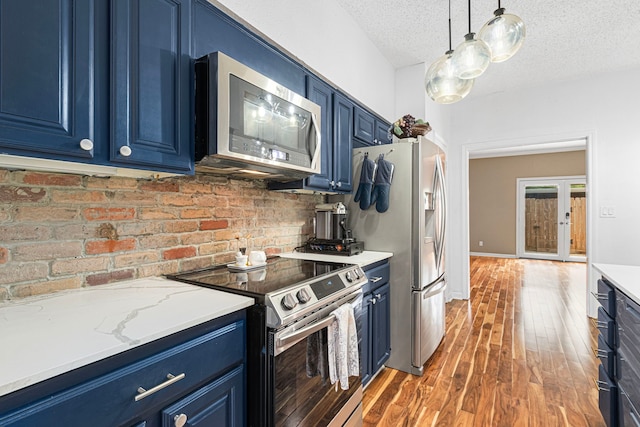 3749 Wakeforest St, Houston, TX 77098 - kitchen with blue cabinets, stainless steel appliances, and a textured ceiling