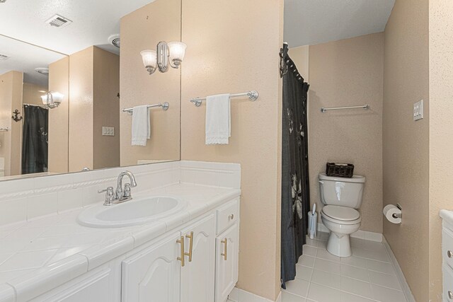3749 Wakeforest St, Houston, TX 77098 - full bathroom featuring vanity, tile patterned floors, toilet, baseboards, and a shower with curtain