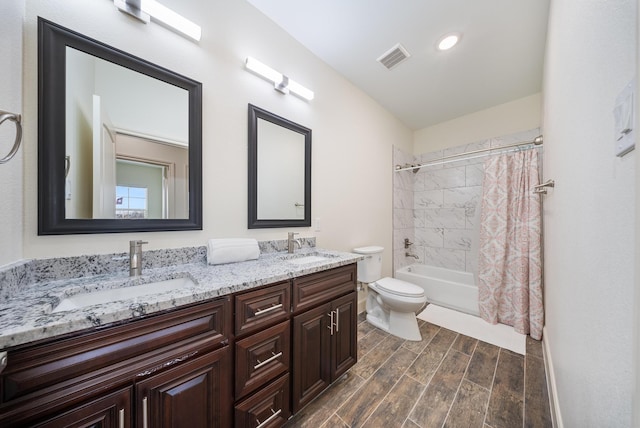 full bath featuring a sink, wood finished floors, shower / bath combo, and toilet