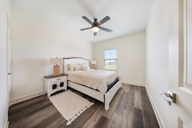 bedroom with a ceiling fan, baseboards, and dark wood finished floors