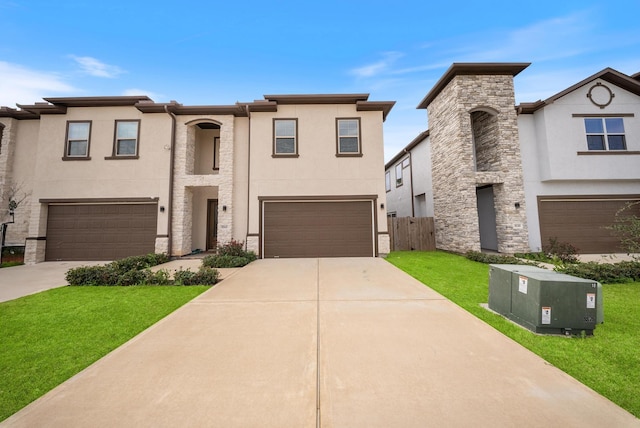 view of front of house featuring a garage, stucco siding, concrete driveway, and a front yard