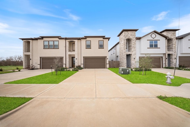 view of front facade featuring a front yard, cooling unit, stucco siding, an attached garage, and driveway