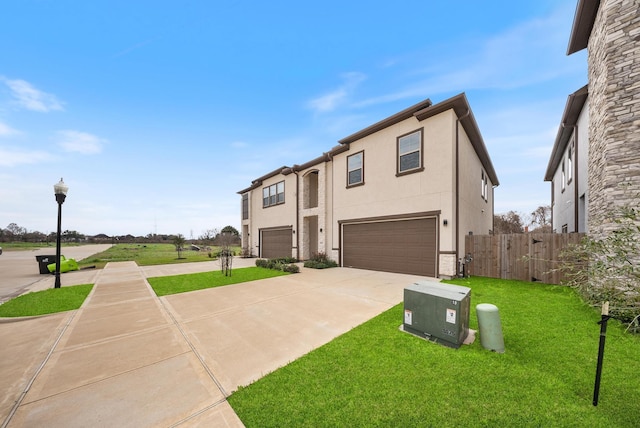 view of front of house featuring fence, a front lawn, a garage, stucco siding, and concrete driveway