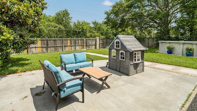 view of patio / terrace with a fenced backyard, an outdoor structure, a shed, and outdoor lounge area