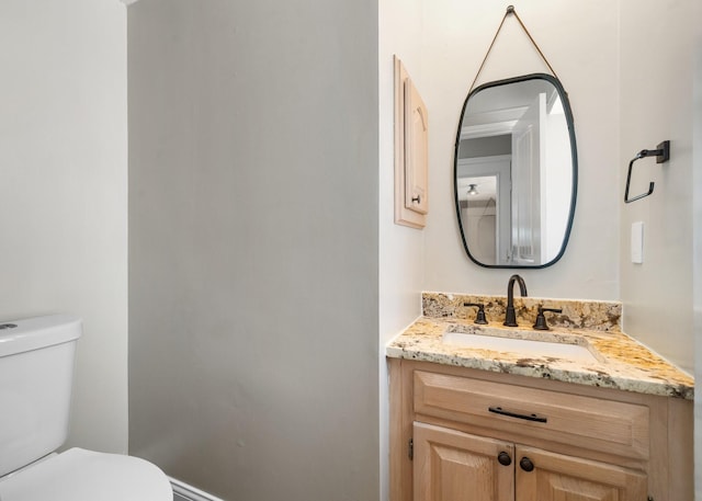 bathroom featuring vanity and toilet