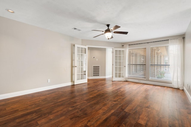 empty room featuring visible vents, baseboards, ceiling fan, and wood finished floors