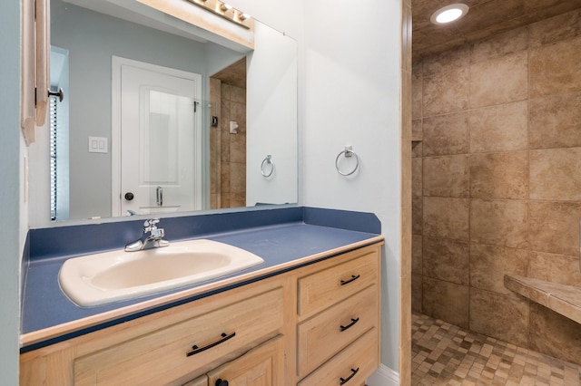bathroom featuring vanity, recessed lighting, and tiled shower