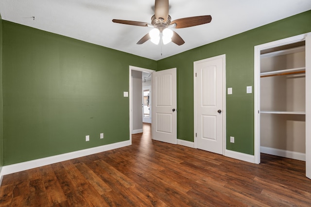 unfurnished bedroom with a closet, baseboards, a ceiling fan, and dark wood-style floors