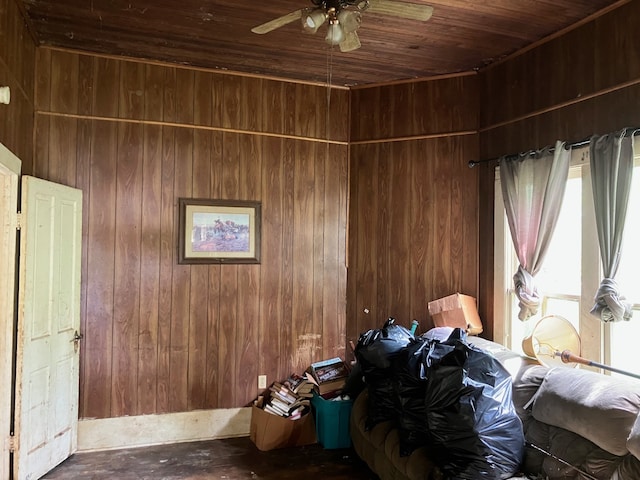 misc room with wood walls, wood ceiling, and a ceiling fan