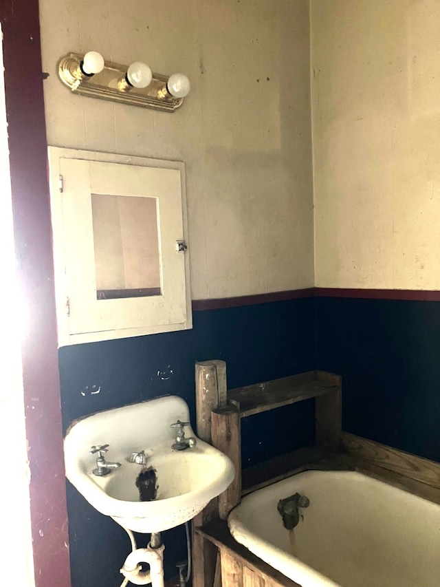 full bath featuring a sink and a bathtub