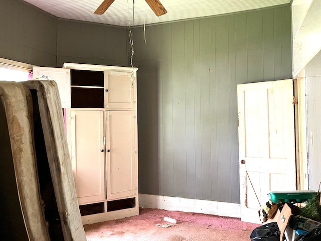 bedroom with a ceiling fan and carpet