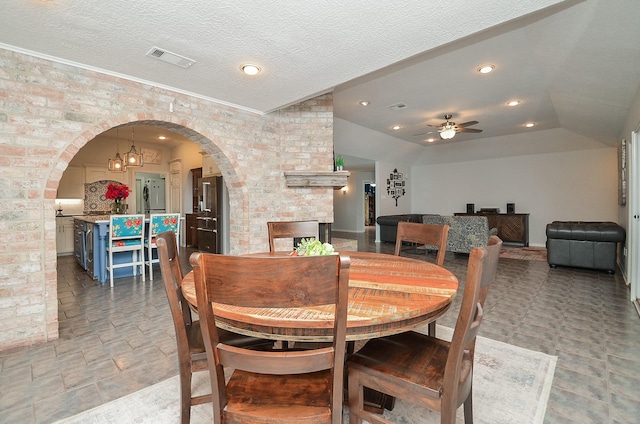 dining room featuring arched walkways, a ceiling fan, recessed lighting, lofted ceiling, and crown molding