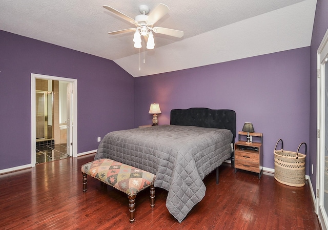 bedroom with vaulted ceiling, baseboards, wood finished floors, ceiling fan, and ensuite bathroom