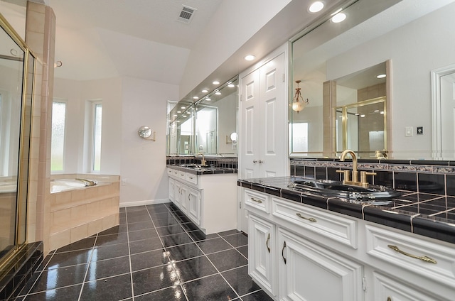 bathroom featuring a stall shower, a bath, recessed lighting, two vanities, and baseboards