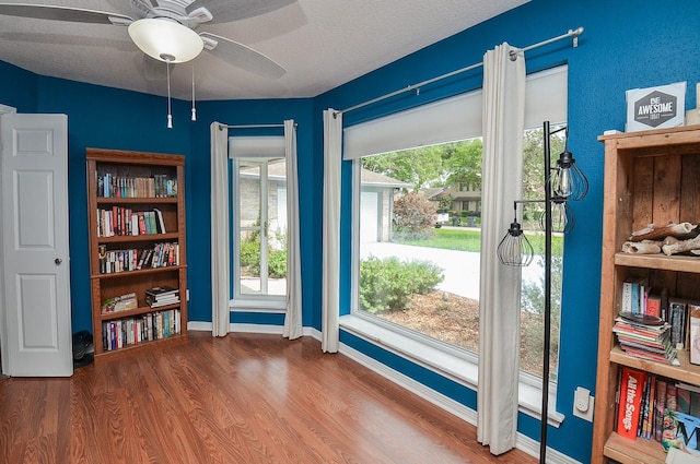 miscellaneous room featuring wood finished floors, ceiling fan, and baseboards