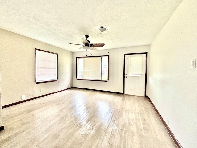 8038 Woodlyn Rd, Houston, TX 77028 - empty room featuring a ceiling fan, a textured ceiling, visible vents, light wood-type flooring, and baseboards