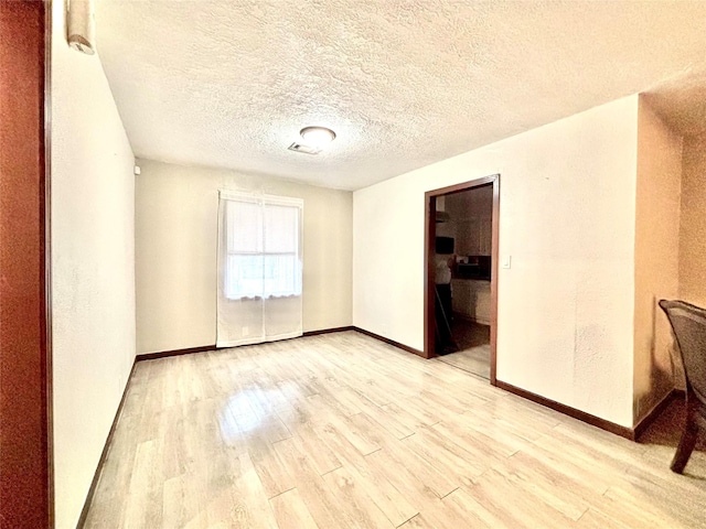 8038 Woodlyn Rd, Houston, TX 77028 - unfurnished room featuring baseboards and light wood-style flooring