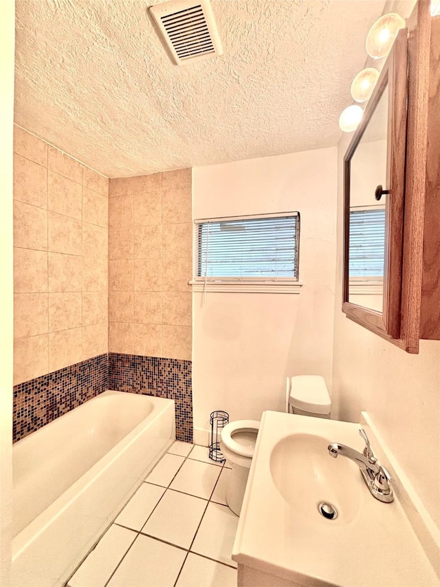 8038 Woodlyn Rd, Houston, TX 77028 - full bath featuring tile patterned floors, toilet, a textured ceiling, and visible vents