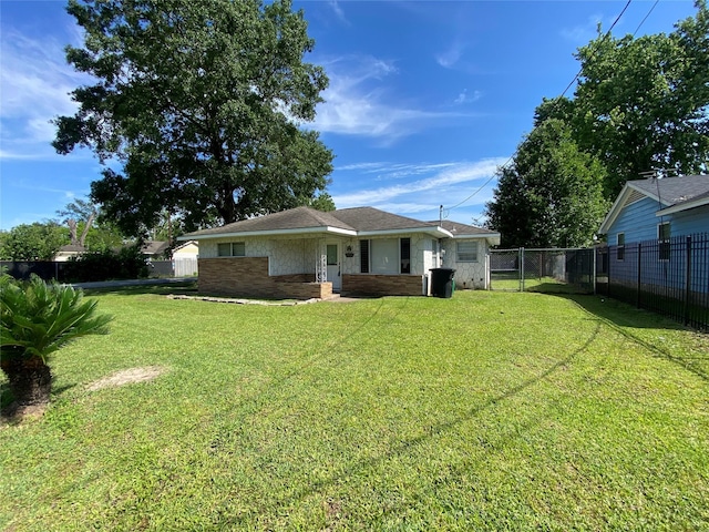 8038 Woodlyn Rd, Houston, TX 77028 - rear view of property featuring a lawn, fence, and brick siding