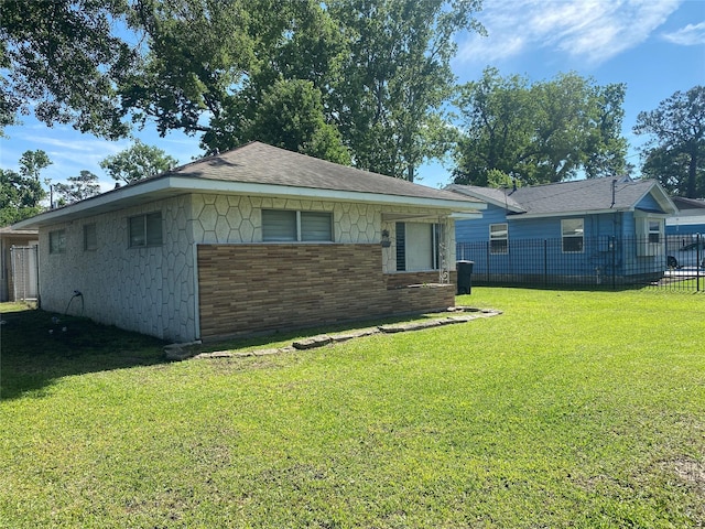 8038 Woodlyn Rd, Houston, TX 77028 - view of front of property featuring fence, brick siding, and a front yard