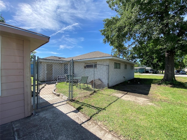 8038 Woodlyn Rd, Houston, TX 77028 - view of property exterior featuring a lawn, fence, and a gate