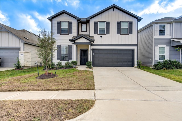 traditional-style house with a garage, board and batten siding, driveway, and a front lawn