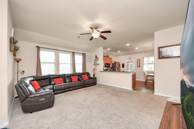 carpeted living room featuring baseboards, recessed lighting, ceiling fan, and visible vents