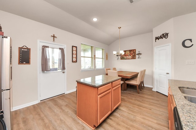 217 Kickapoo Dr, Anahuac, TX 77514 - kitchen featuring light stone counters, a notable chandelier, light wood-type flooring, and baseboards