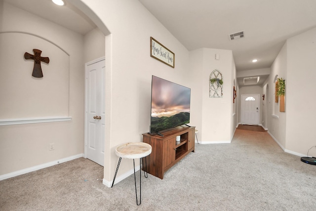 217 Kickapoo Dr, Anahuac, TX 77514 - living area with arched walkways, carpet flooring, visible vents, and baseboards