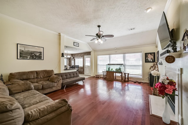 20319 Concord Hill Dr, Cypress, TX 77433 - living room featuring a textured ceiling, ceiling fan with notable chandelier, vaulted ceiling, visible vents, and dark wood-style floors