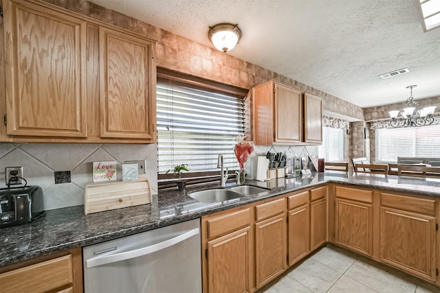 20319 Concord Hill Dr, Cypress, TX 77433 - kitchen featuring stainless steel dishwasher, a sink, a textured ceiling, and a chandelier