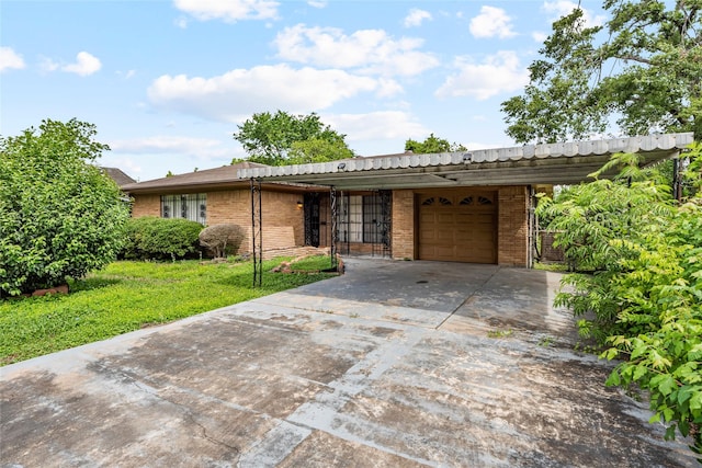 ranch-style house featuring a garage, a front yard, driveway, and brick siding