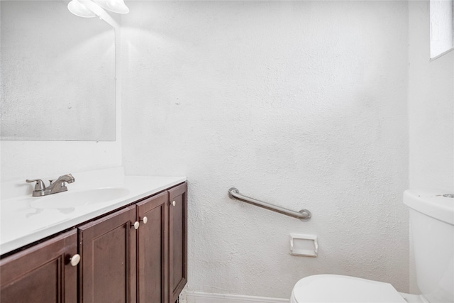 half bathroom featuring toilet and vanity