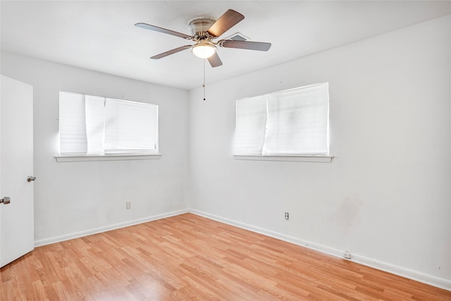 spare room featuring baseboards, ceiling fan, and light wood-style flooring