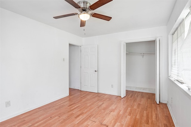 unfurnished bedroom featuring a closet, light wood-style flooring, ceiling fan, and baseboards