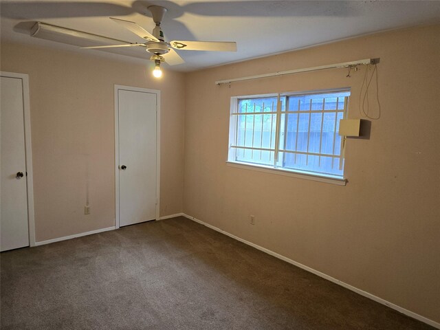 unfurnished bedroom with carpet, baseboards, and a ceiling fan