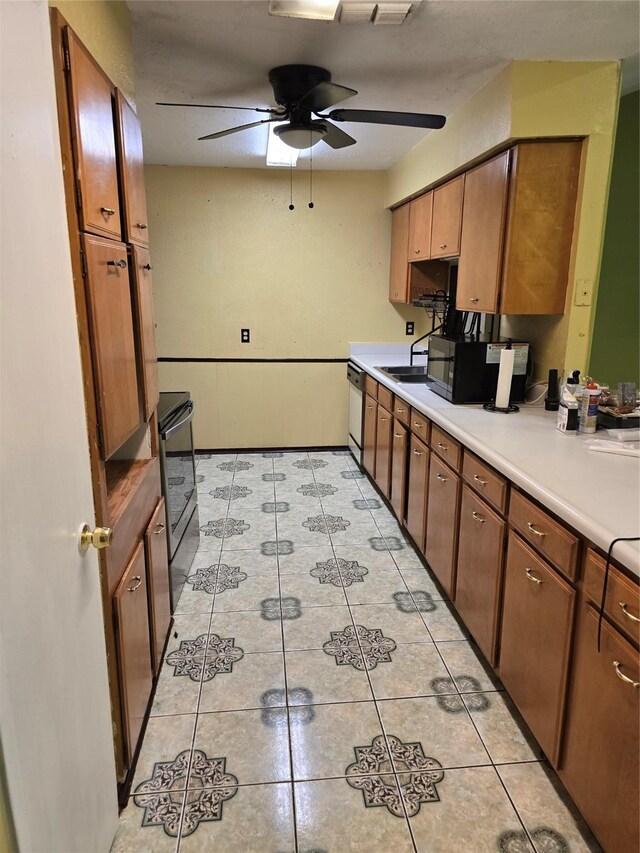 kitchen featuring dishwasher, stainless steel range with electric stovetop, ceiling fan, black microwave, and light tile patterned floors