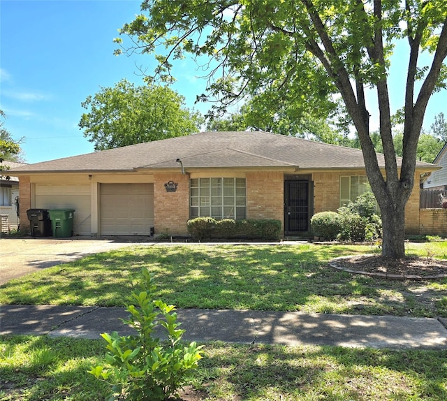 single story home featuring brick siding, concrete driveway, a garage, a front yard, and roof with shingles