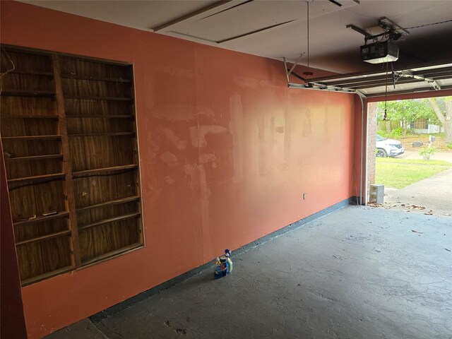 garage with a garage door opener and baseboards