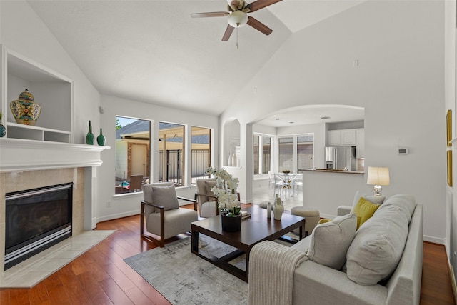 5514 Chase Hbr, Houston, TX 77041 - living room featuring arched walkways, ceiling fan, wood-type flooring, a fireplace, and high vaulted ceiling