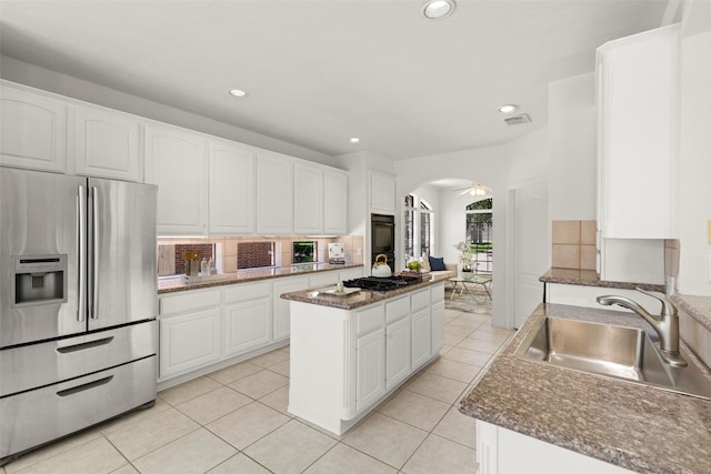 5514 Chase Hbr, Houston, TX 77041 - kitchen featuring black appliances, a sink, arched walkways, recessed lighting, and white cabinets